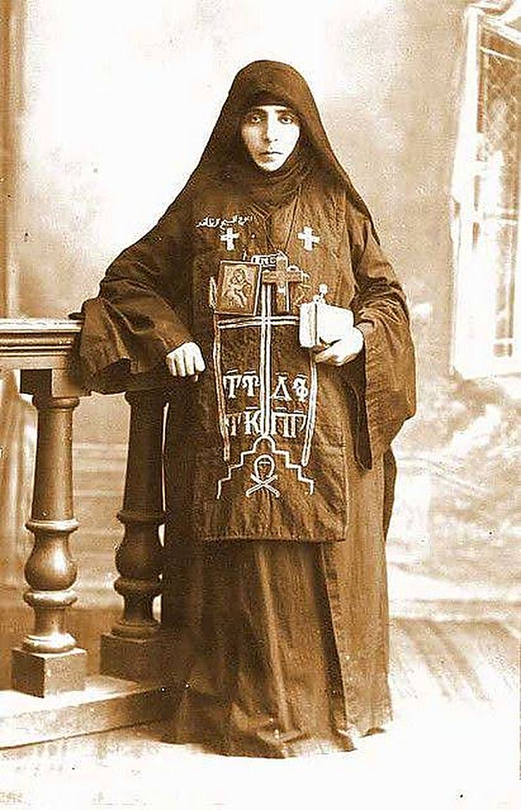 A nun, holding her cross