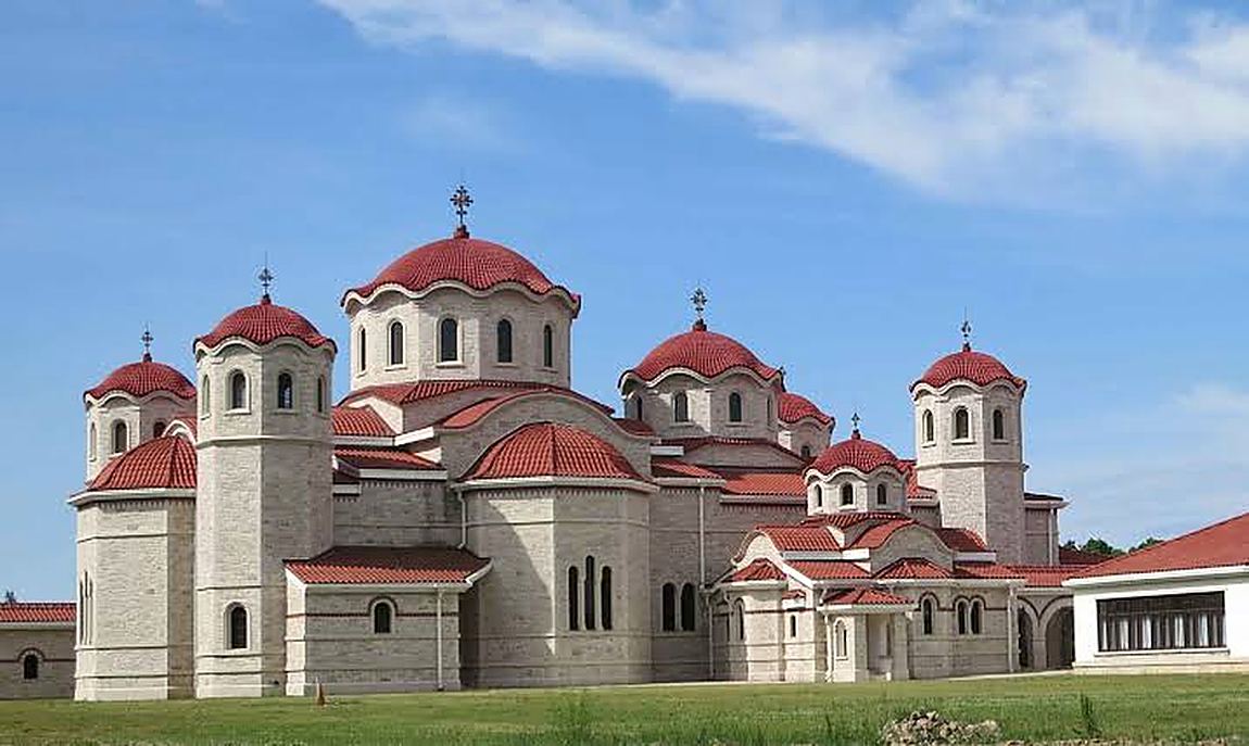 A monastery, walled like a small town